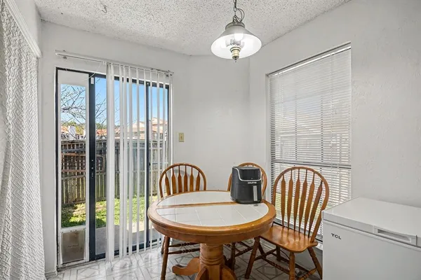 a view of a dining room with furniture wooden floor and chandelier
