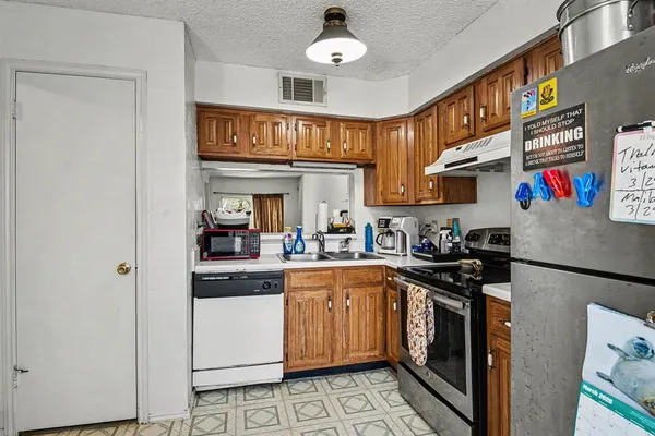 a kitchen with stainless steel appliances granite countertop a stove and a sink
