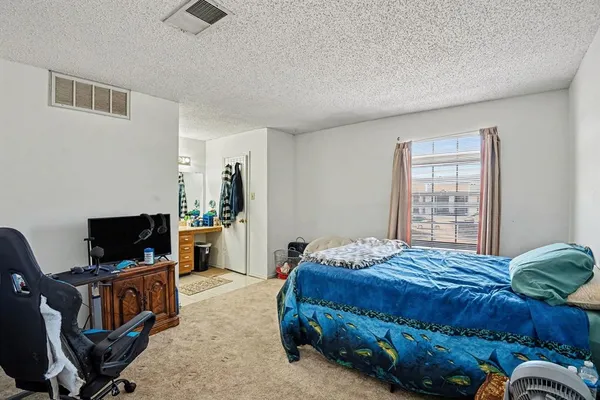 a bedroom with a bed and flat screen tv