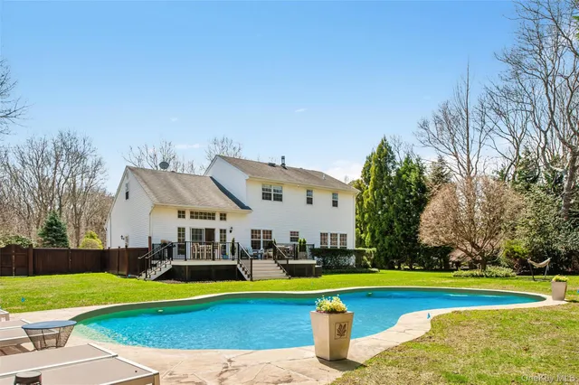a view of a house with swimming pool and yard