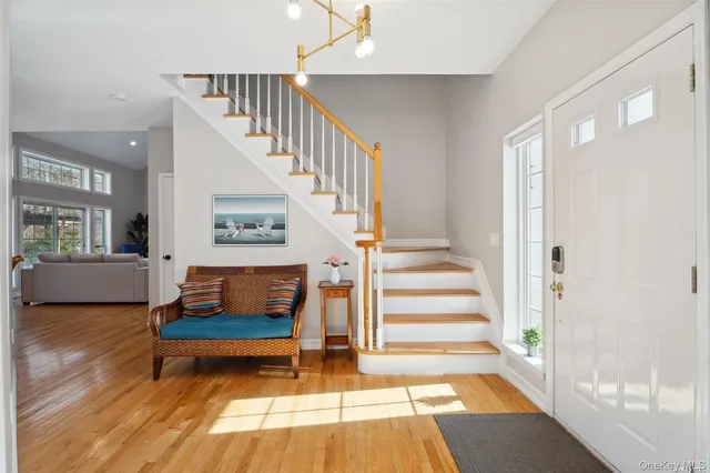 a view of entryway and hall with wooden floor