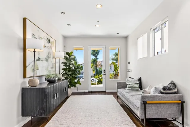 a living room with furniture and a potted plant