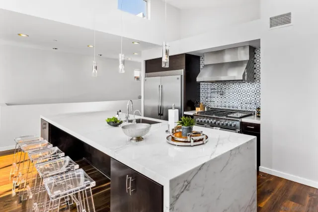 a kitchen with stainless steel appliances a sink and a stove