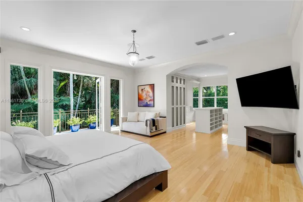 a bedroom with a large bed and a window