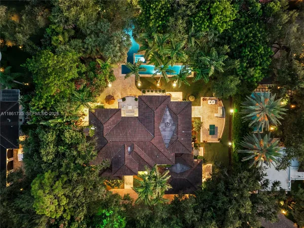 an aerial view of a house with a yard and swimming pool