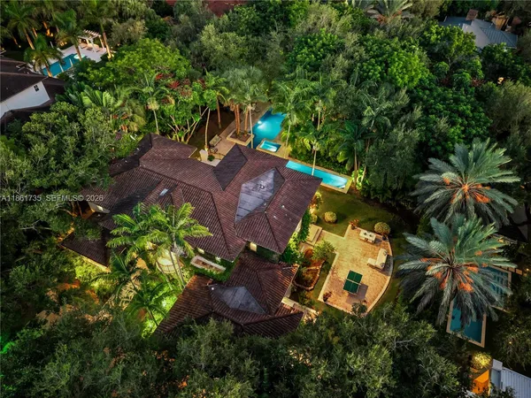 an aerial view of a house with a yard