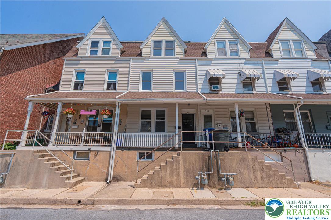 a view of a white house with large windows