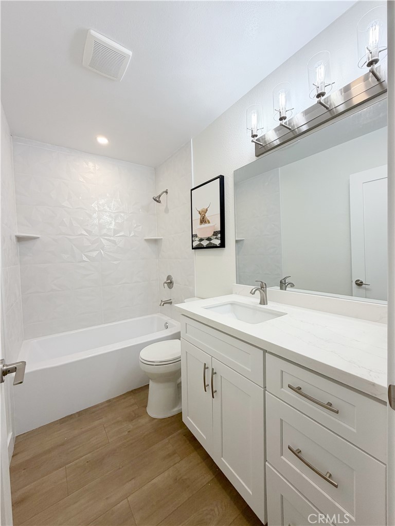 212 South Kraemer, Unit 2208 Placentia, CA 92870 - Photo 13 of 16 a bathroom with a toilet a sink a tub and a mirror