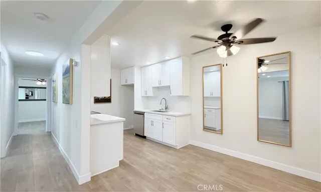 a open kitchen with white cabinets and stainless steel appliances