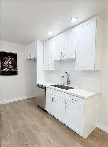 a kitchen with a sink cabinets and a window