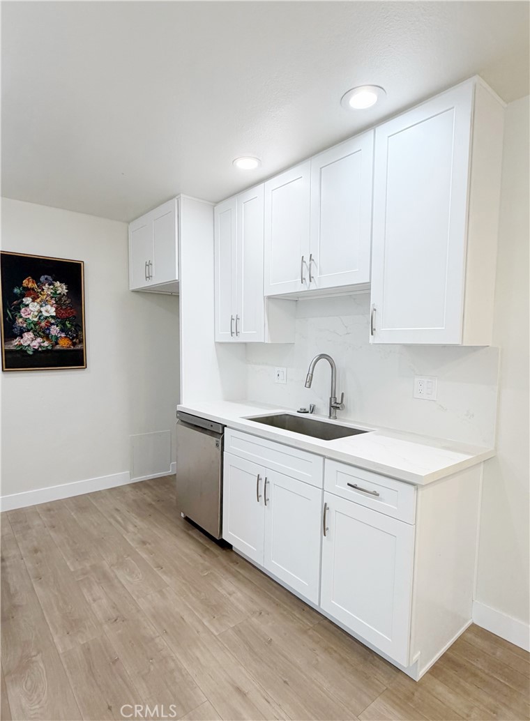 212 South Kraemer, Unit 2208 Placentia, CA 92870 - Photo 9 of 16 a kitchen with a sink cabinets and a window