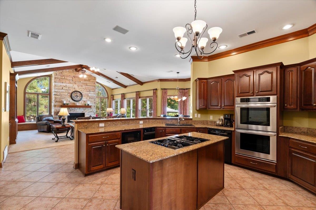 1226 Oak Lake Circle Collierville, TN 38017 - Photo 12 of 39 a kitchen filled with stainless steel appliances granite countertop a stove and a sink