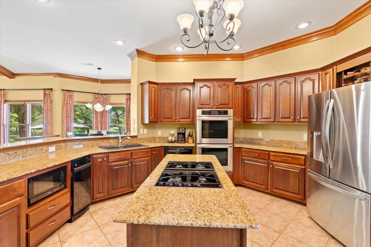 1226 Oak Lake Circle Collierville, TN 38017 - Photo 13 of 39 a kitchen with stainless steel appliances a stove a sink and a refrigerator