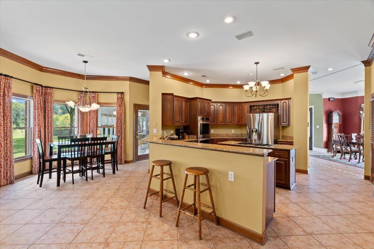 1226 Oak Lake Circle Collierville, TN 38017 - Photo 15 of 39 a kitchen with stainless steel appliances granite countertop table chairs sink and cabinets