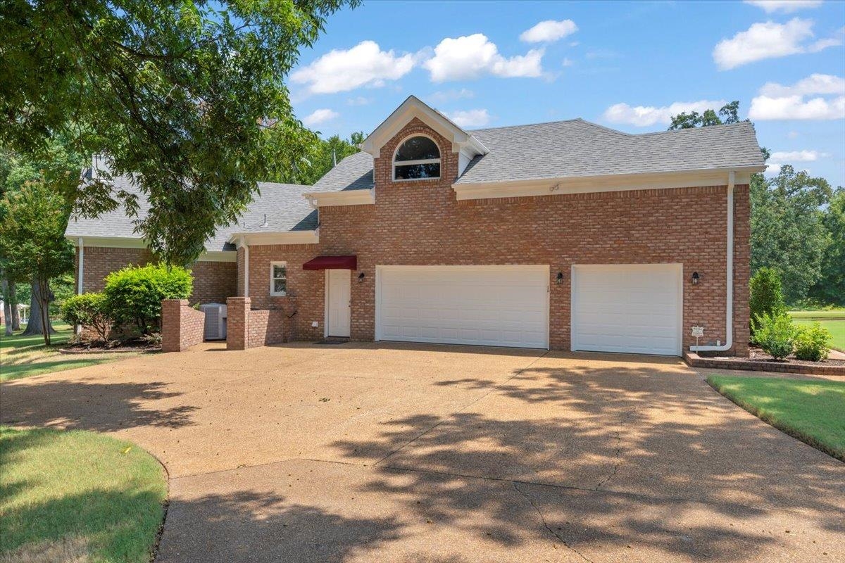 1226 Oak Lake Circle Collierville, TN 38017 - Photo 4 of 39 a front view of a house with a yard and garage
