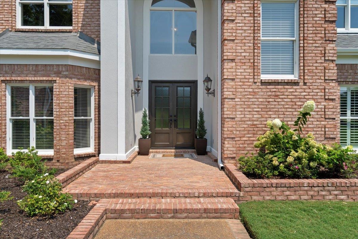 1226 Oak Lake Circle Collierville, TN 38017 - Photo 6 of 39 a view of a brick house with plants and large tree