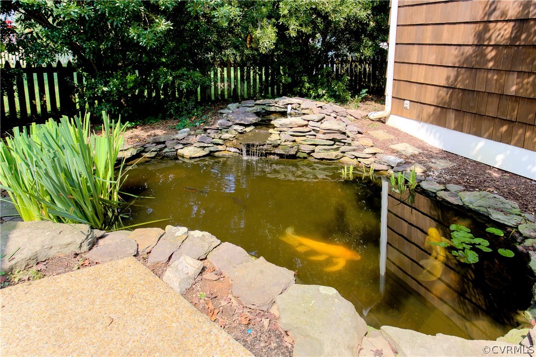 5015 Caledonia Road Richmond, VA 23225 - Photo 24 of 29 Koi pond featuring a water fall, water lilies, and