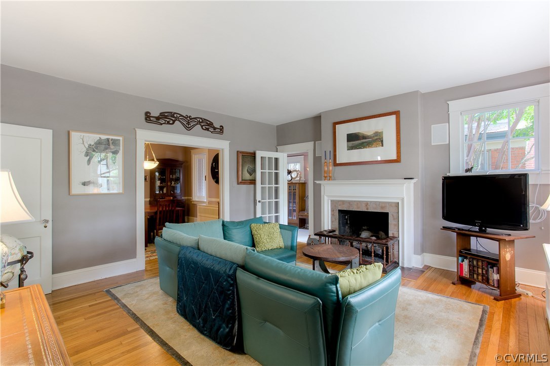 The cozy living room is welcoming with hardwood fl