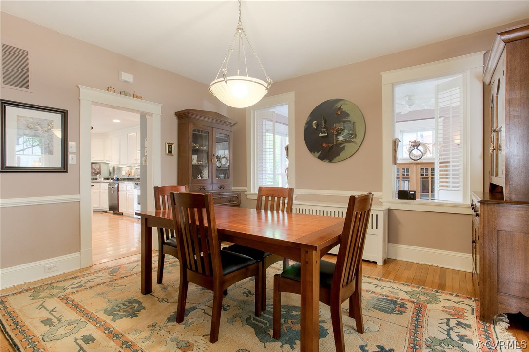 Formal dining room with hardwood floors, chair rai