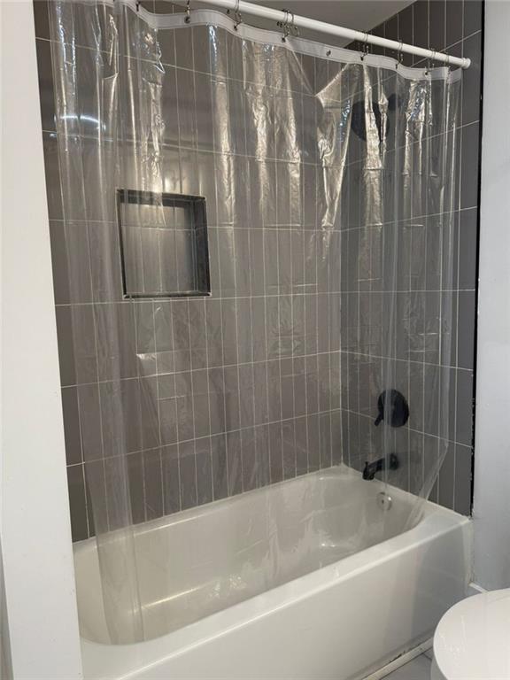 273 Wadley Street Northwest Atlanta, GA 30314 - Photo 13 of 17 a bathroom with a shower and a toilet