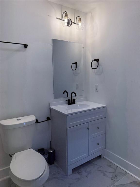 273 Wadley Street Northwest Atlanta, GA 30314 - Photo 14 of 17 a bathroom with a sink a toilet and a mirror