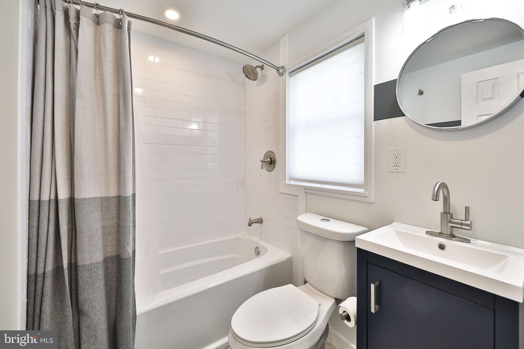 3217 Turner Street Philadelphia, PA 19121 - Photo 11 of 18 a bathroom with a sink toilet a shower and a mirror