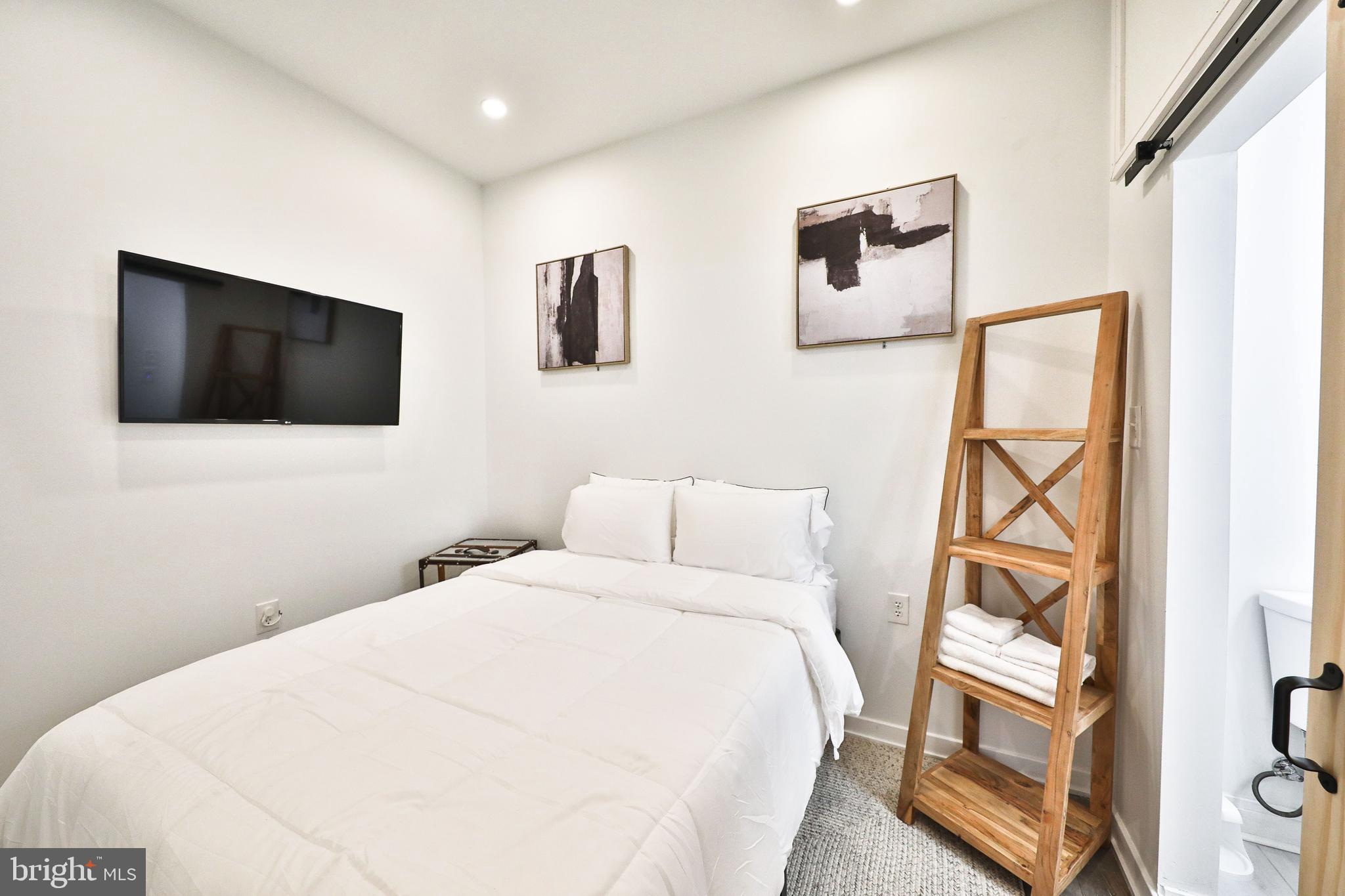 3217 Turner Street Philadelphia, PA 19121 - Photo 12 of 18 a bedroom with a bed and a flat screen tv