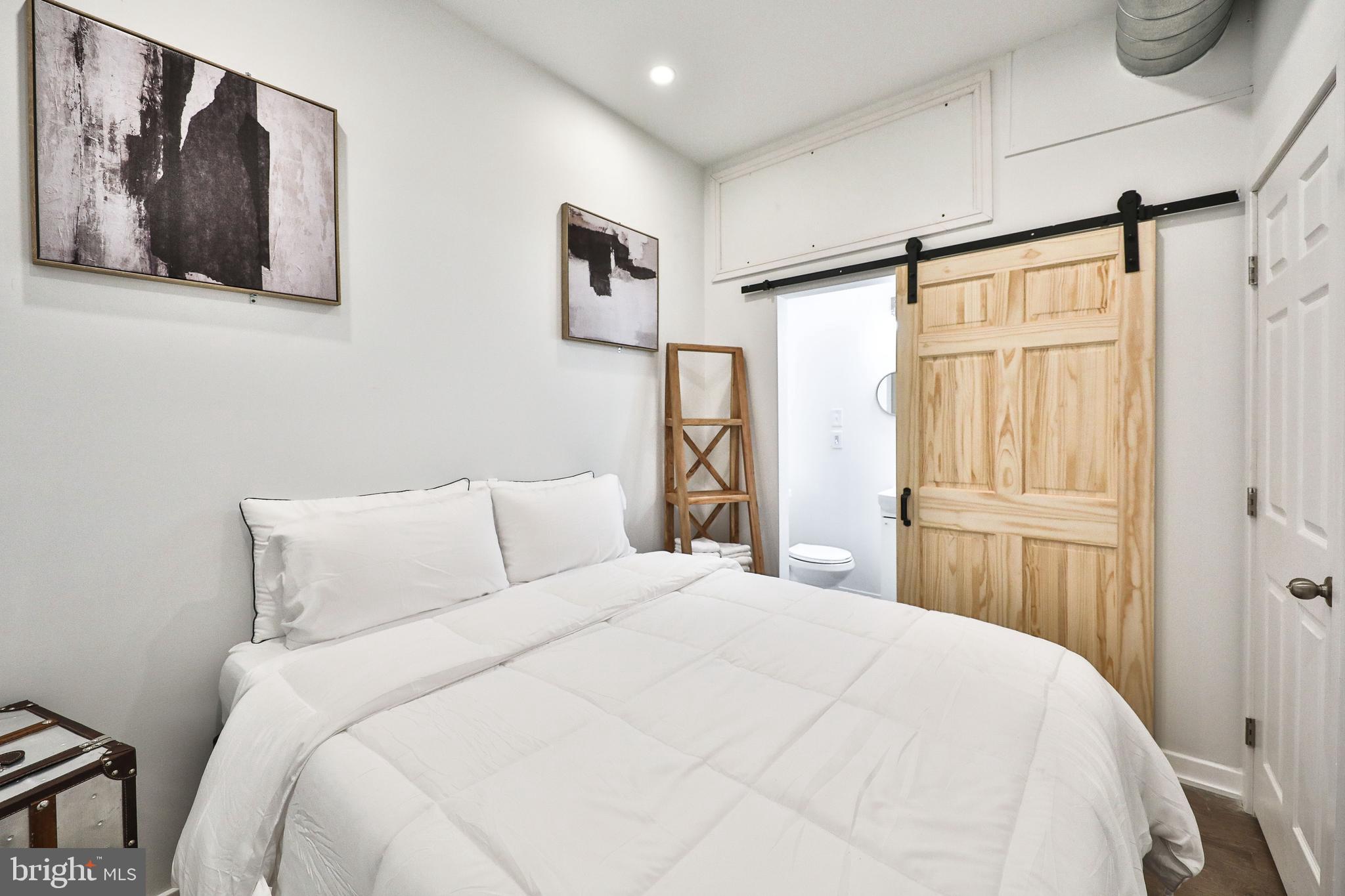 3217 Turner Street Philadelphia, PA 19121 - Photo 13 of 18 a bedroom with a large bed and a window