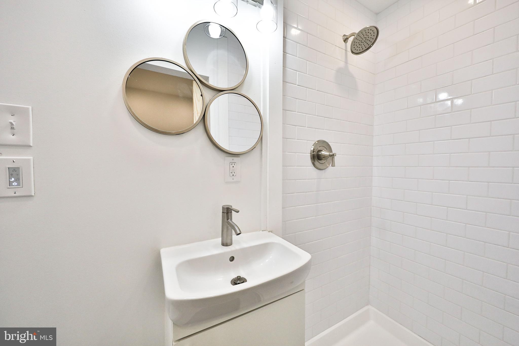 3217 Turner Street Philadelphia, PA 19121 - Photo 14 of 18 a bathroom with a sink mirror and vanity