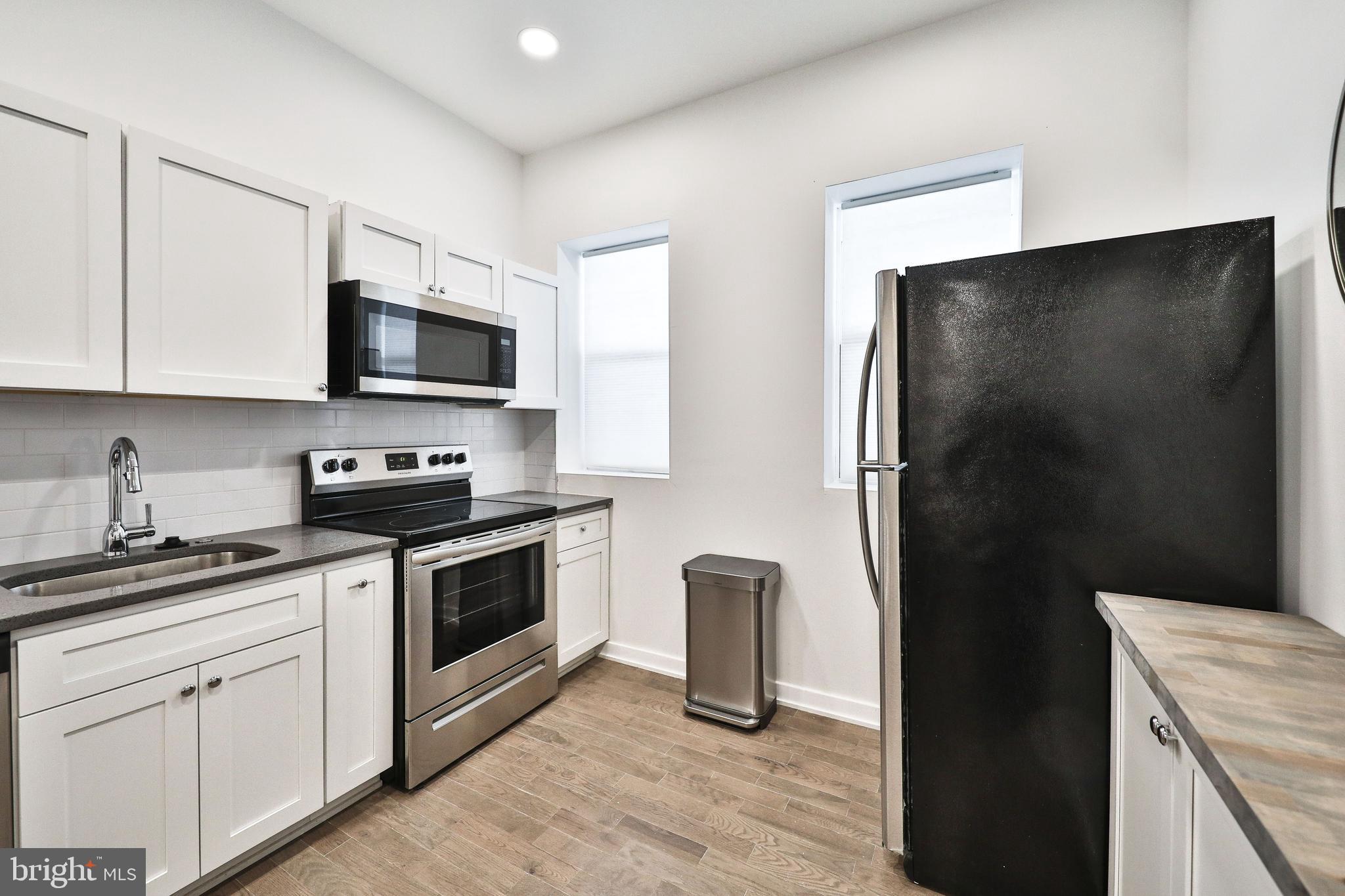 3217 Turner Street Philadelphia, PA 19121 - Photo 7 of 18 a kitchen with a refrigerator stove and sink