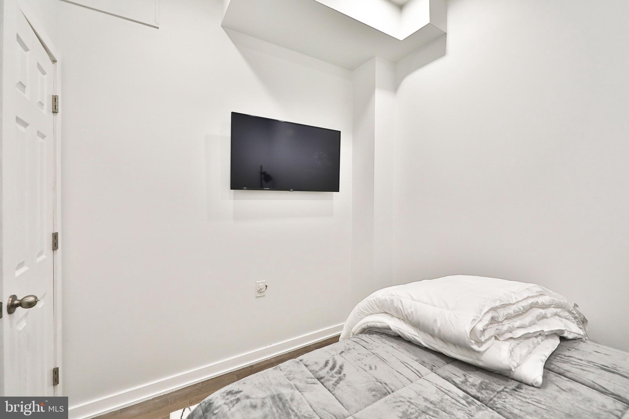 3217 Turner Street Philadelphia, PA 19121 - Photo 10 of 18 a bedroom with a bed and a flat screen tv