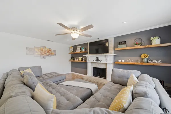 a living room with furniture fireplace and flat screen tv