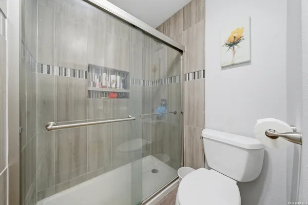 a bathroom with a toilet and a shower
