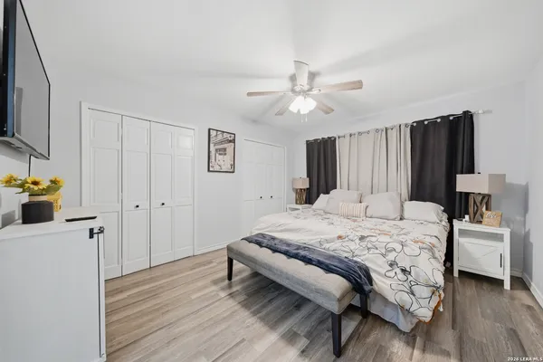 a bedroom with a bed and a flat screen tv
