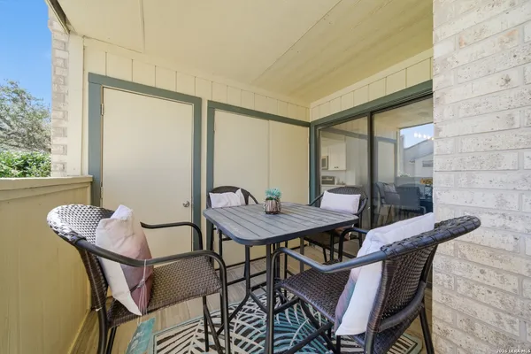a view of a balcony dining area with furniture
