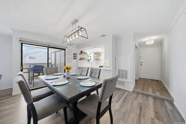 a view of a dining room with furniture window and wooden floor