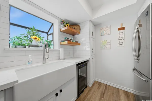 a kitchen with a refrigerator and a sink