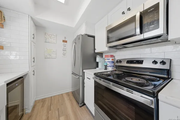 a kitchen with stainless steel appliances a stove a microwave and a refrigerator