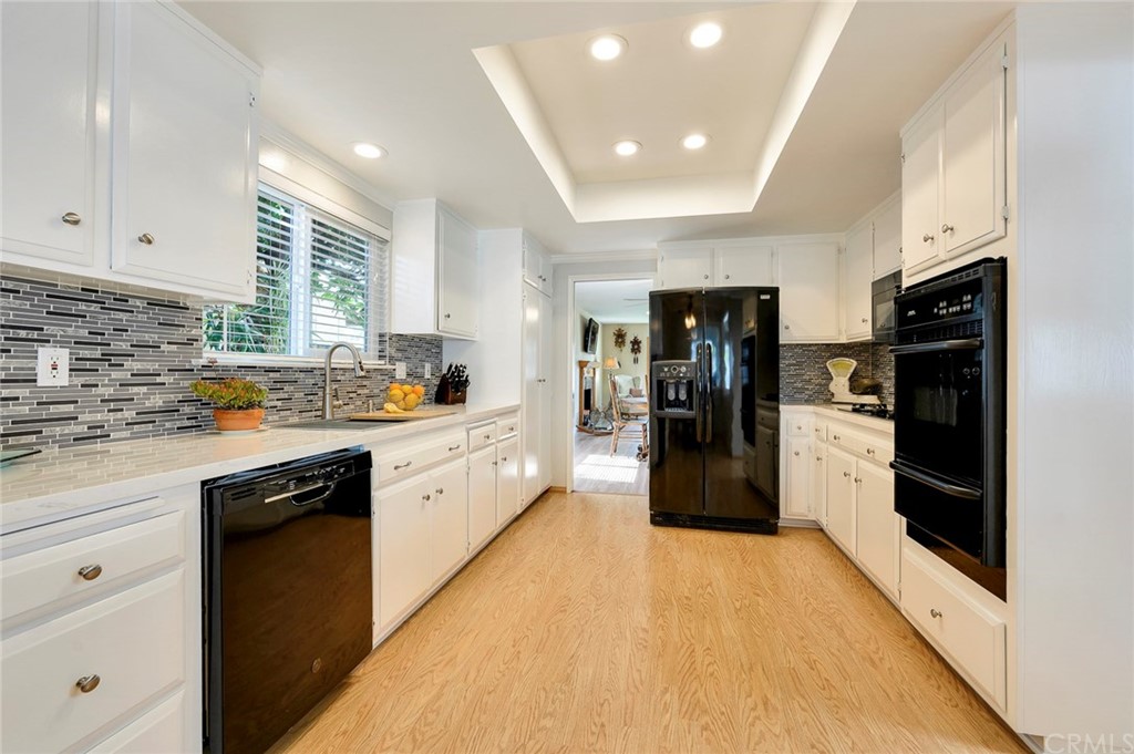 Remodeled kitchen with quartz counter tops, painted cabinets, deep stainless steel sink & fridge that stays.
