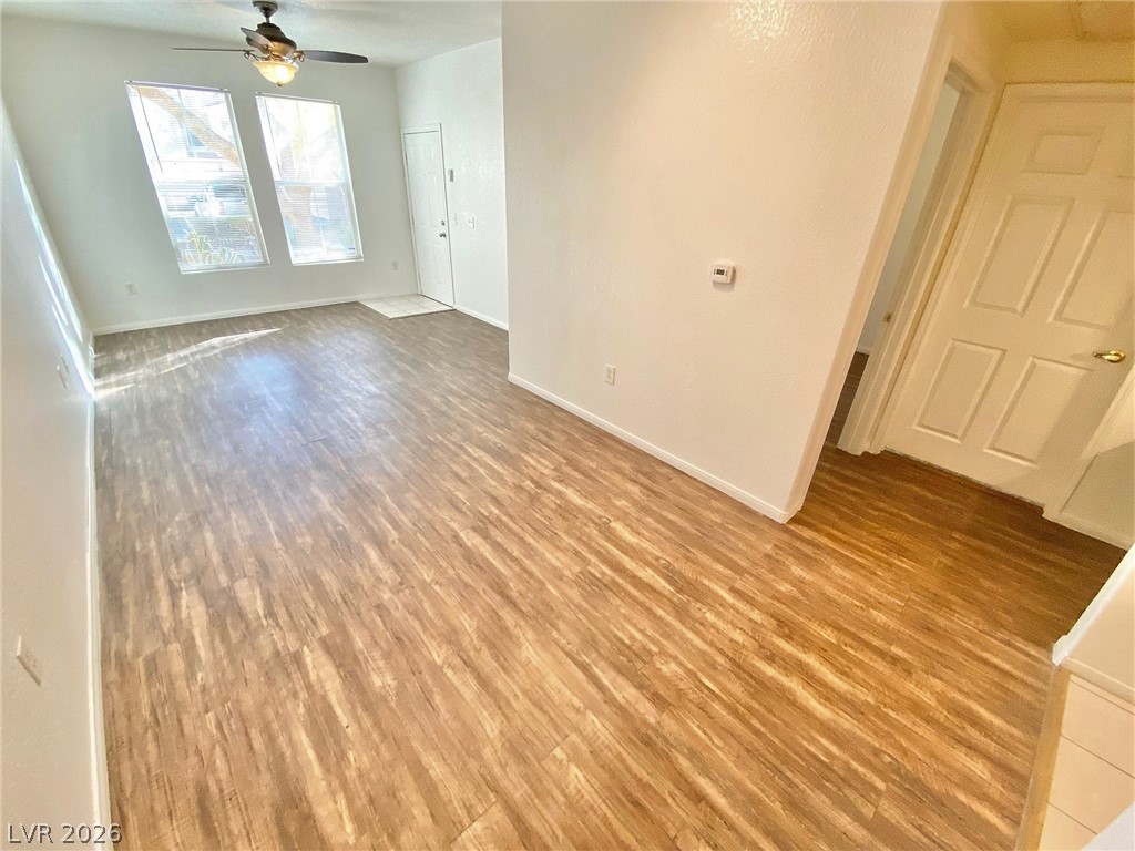 10550 West Alexander Road, Unit 1131 Las Vegas, NV 89129 - Photo 3 of 18 A versatile living space with light wood-style flooring and soaring ceilings invites personalized decor.
