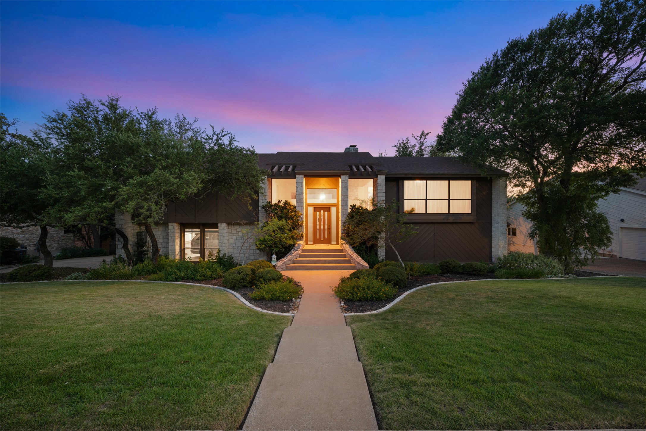 5319 Musket Ridge Austin, TX 78759 - Photo 1 of 39 A well-maintained lawn and manicured landscaping welcome you to this elegant residence at twilight.
