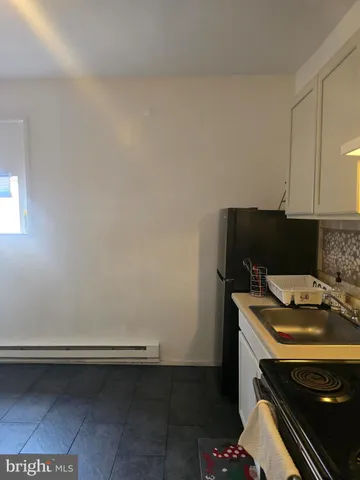 a room with a stove and a microwave