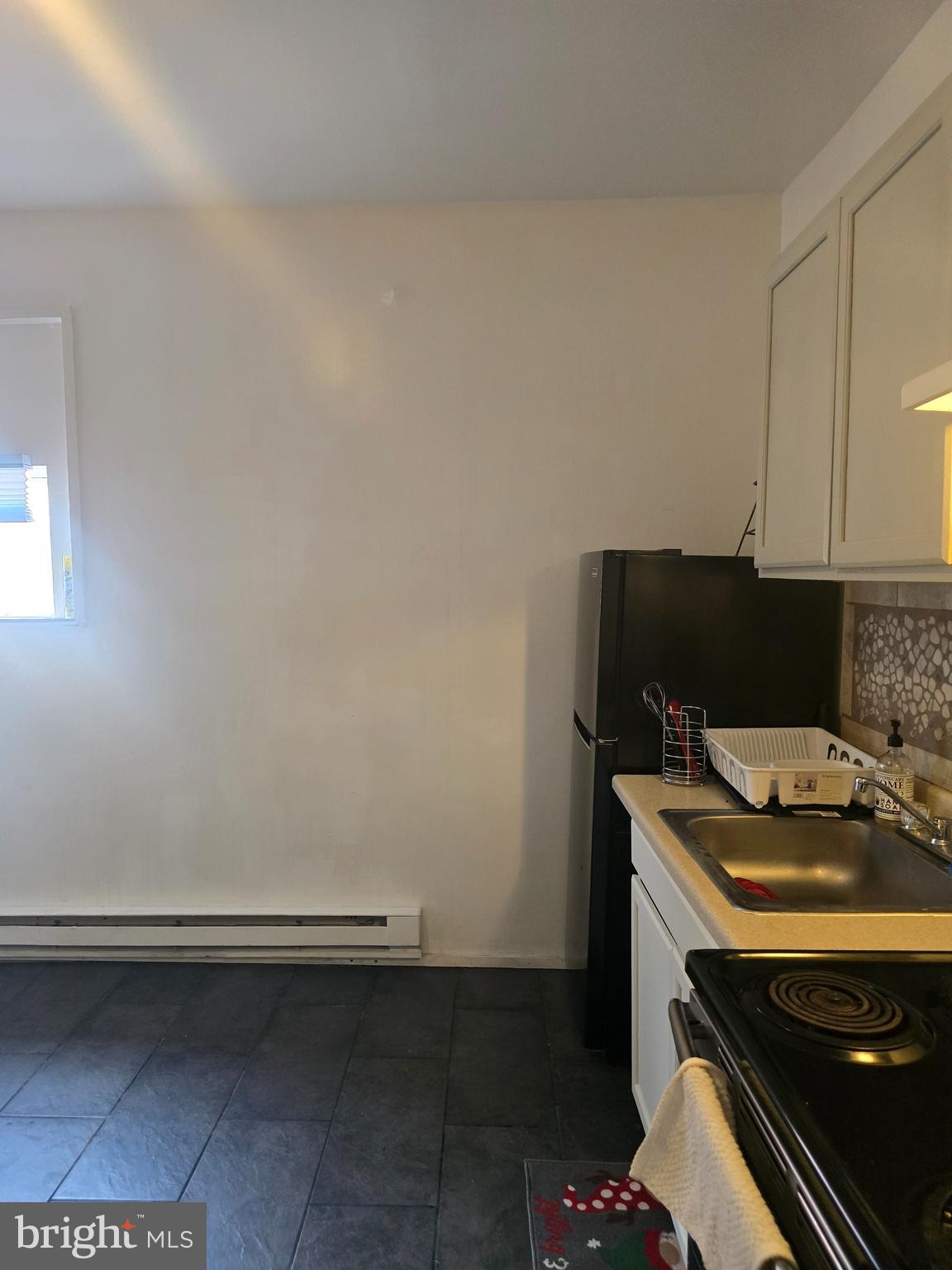 4328 Frankford Avenue, Unit 3A Philadelphia, PA 19124 - Photo 4 of 19 a room with a stove and a microwave