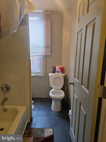 a view of a brick house with a backyard