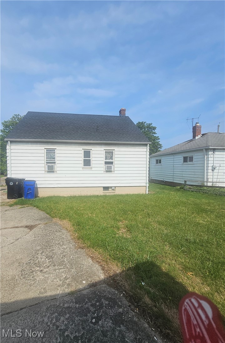 4407 Wyatt Road Cleveland, OH 44128 - Photo 3 of 25 Rear view of house with roof with shingles and a yard
