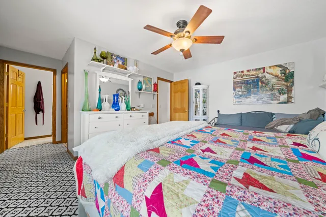 a bathroom with a toilet sink vanity granite and shower