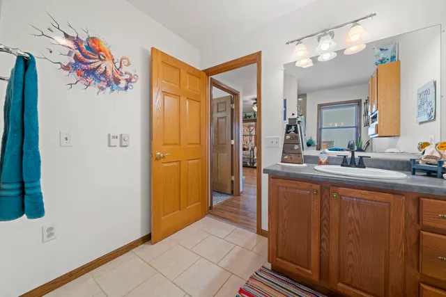 a bedroom with a bed dresser and a window