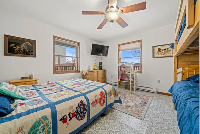 a bedroom with two beds and a window