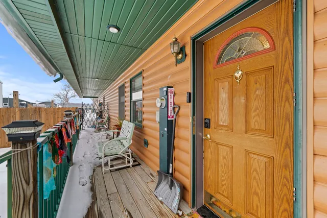 a view of a house with wooden roof and wooden fence