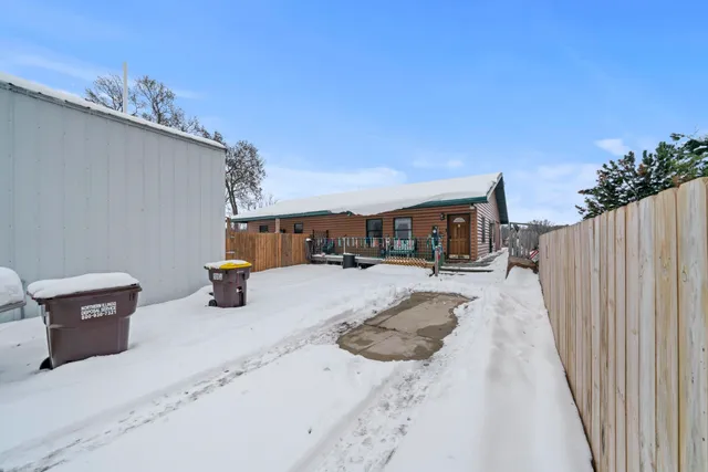 a view of house with snow on the road